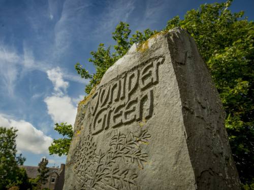 Stone monument commemorating the story of Juniper Green Stone monument commemorating the story of Juniper Green