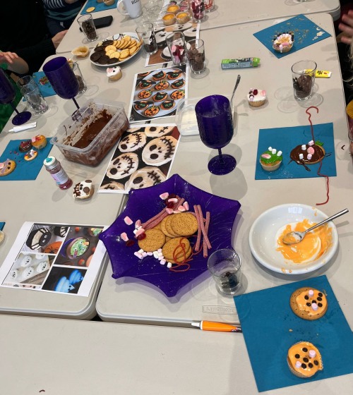 Family Halloween fun decorating cake  and biscuits